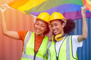LGBTQ workers holding a LBGTQ flag